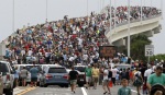 Spectators line the A.Max Brewer bridge in anticipation of the launch of the space shuttle Atlantis in Titusville